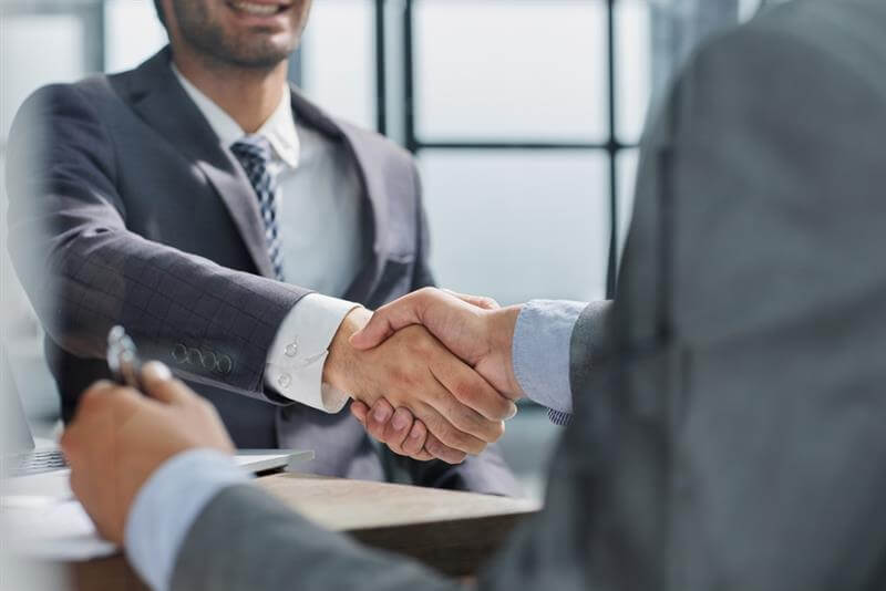 Business people shaking hands during a business meeting .