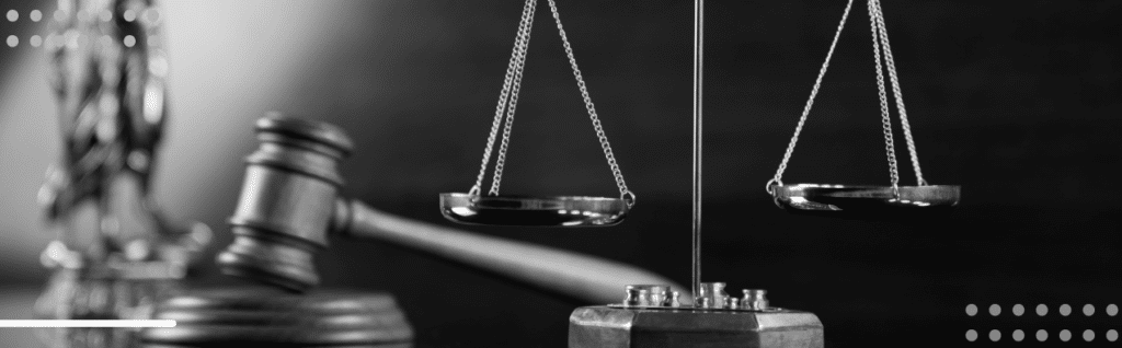 Gavel and balanced scales in detailed black and white, symbolizing justice and order.