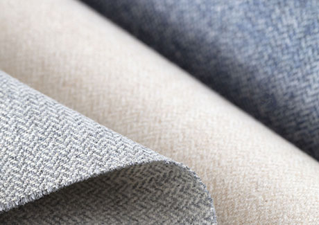 Product shot of fabric for thermal insulated curtains, focusing on synthetic fabrics in multiple colors such as blue, white and grey