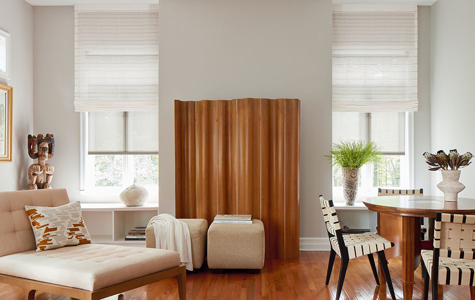 Flat Roman Shades made of Sahara Stripe in Desert are used as alternatives to Scandinavian curtains in a lounge filled with wood tones