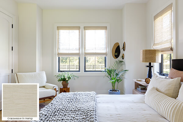 One of the current 2026 window treatment trends is the use of warm neutrals seen on these woven wood shades in a guest bedroom