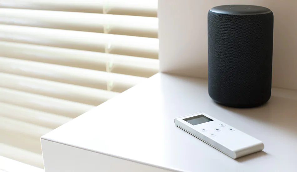 A motorization remote and smart home device used to control and close blinds automatically sits on a table, showing how to put blinds down with motorization