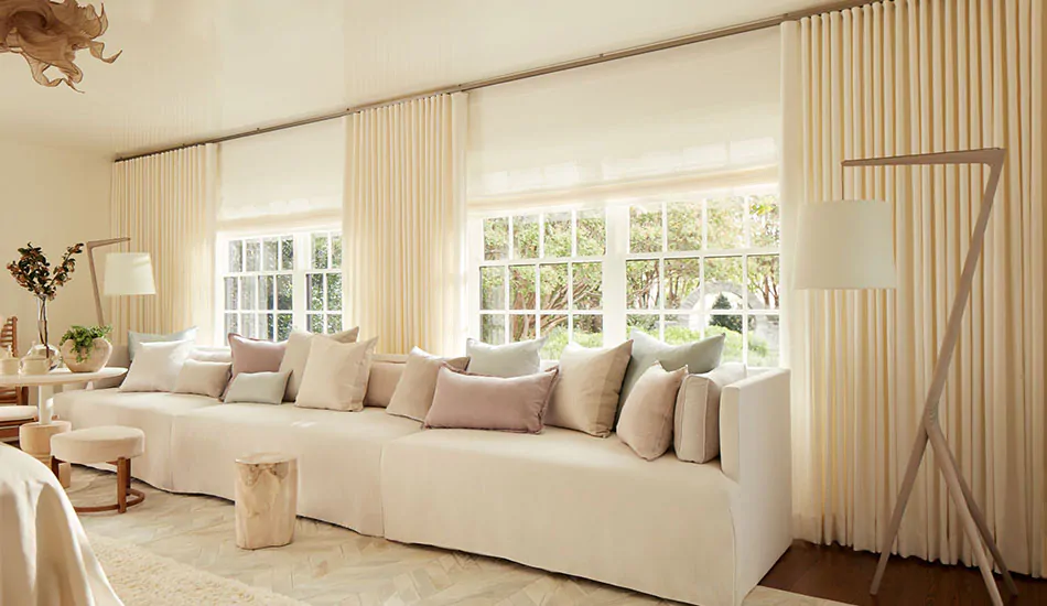 Ripple Fold Drapery in Heathered Linen in Ivory in a cream-colored living room, showing floor-length curtains and where curtains should fall for a float-length look.
