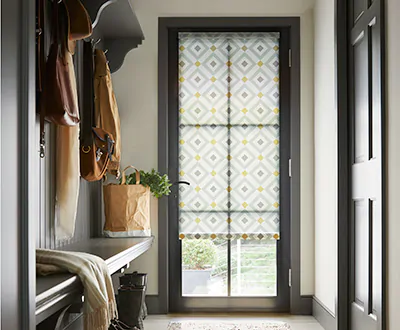 Patterned Roman Shades provide privacy and light control as front door window treatments.
