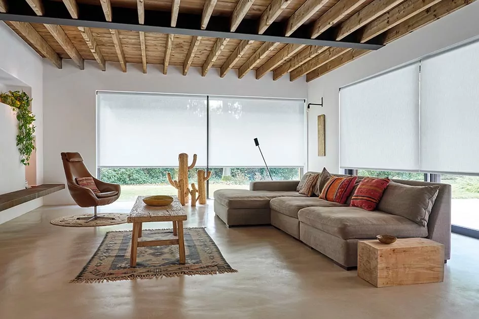 Mcm window treatments include minimalist off-white solar shades over large glass windows