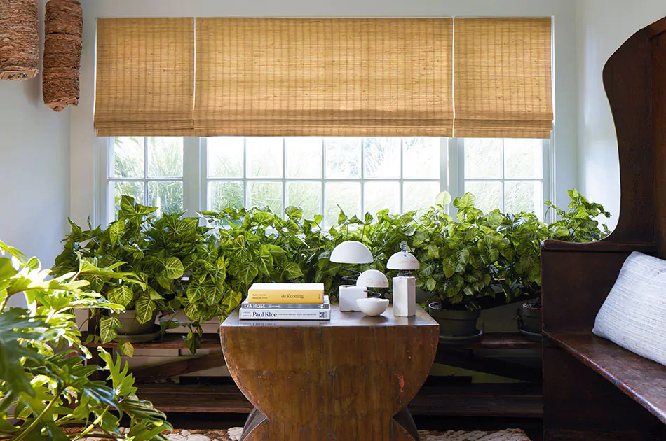 Sunroom with woven wood shades, illustrating natural window shade options and different kinds of window shades with organic texture