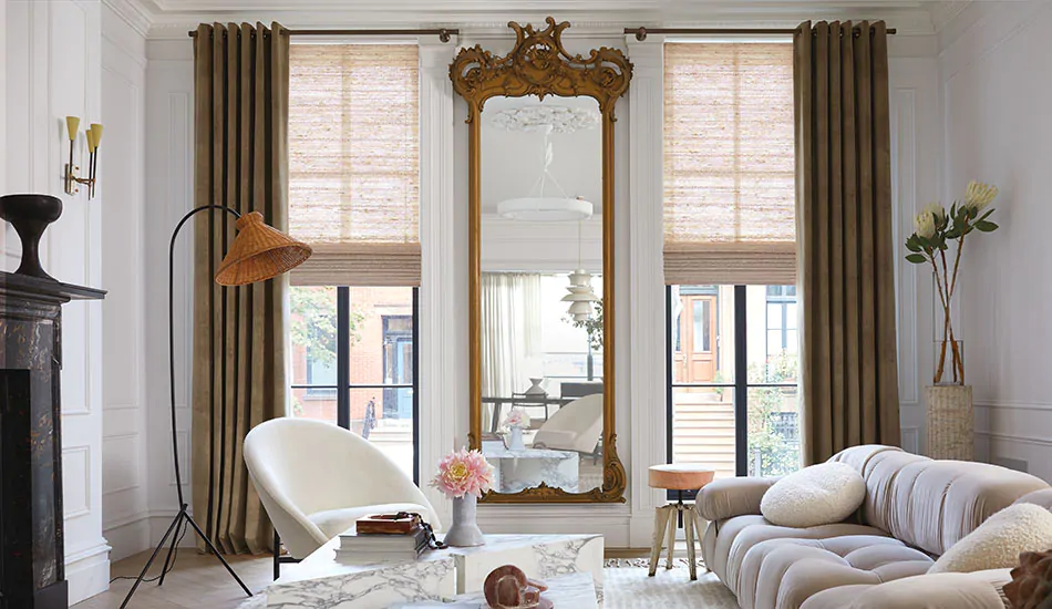 A stylish transitional room features tall windows with Grommet Drapery made of Velvet in Camel for a dramatic effect